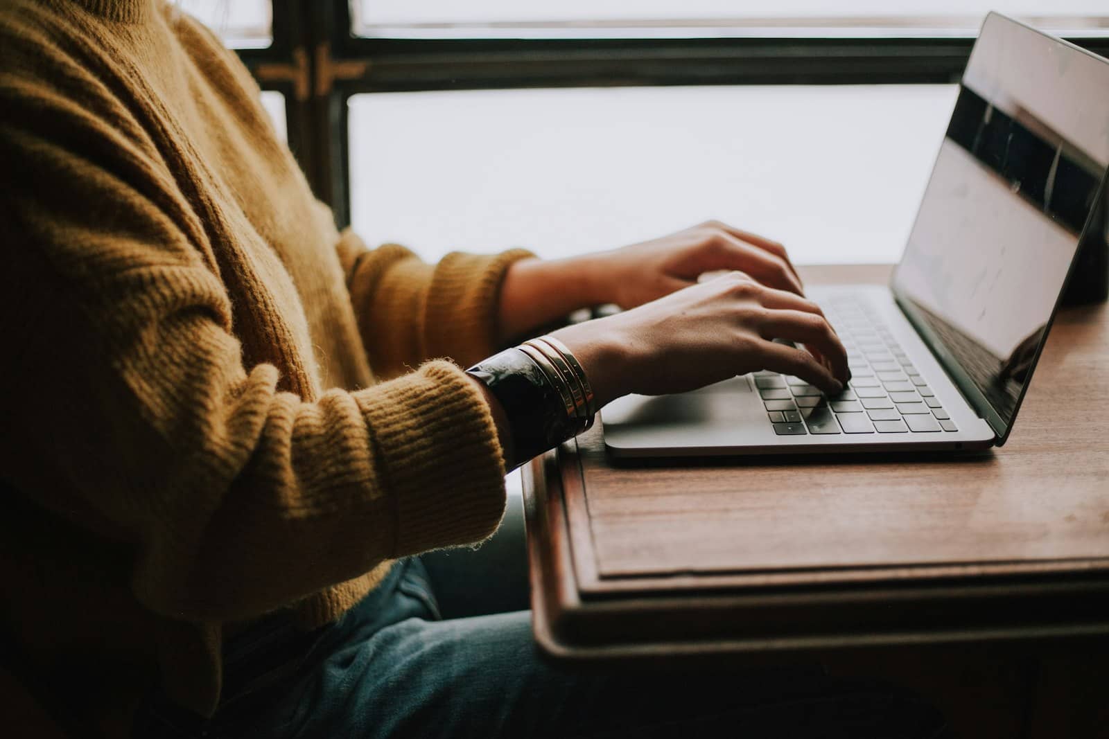 A person at a laptop working through customer conversations