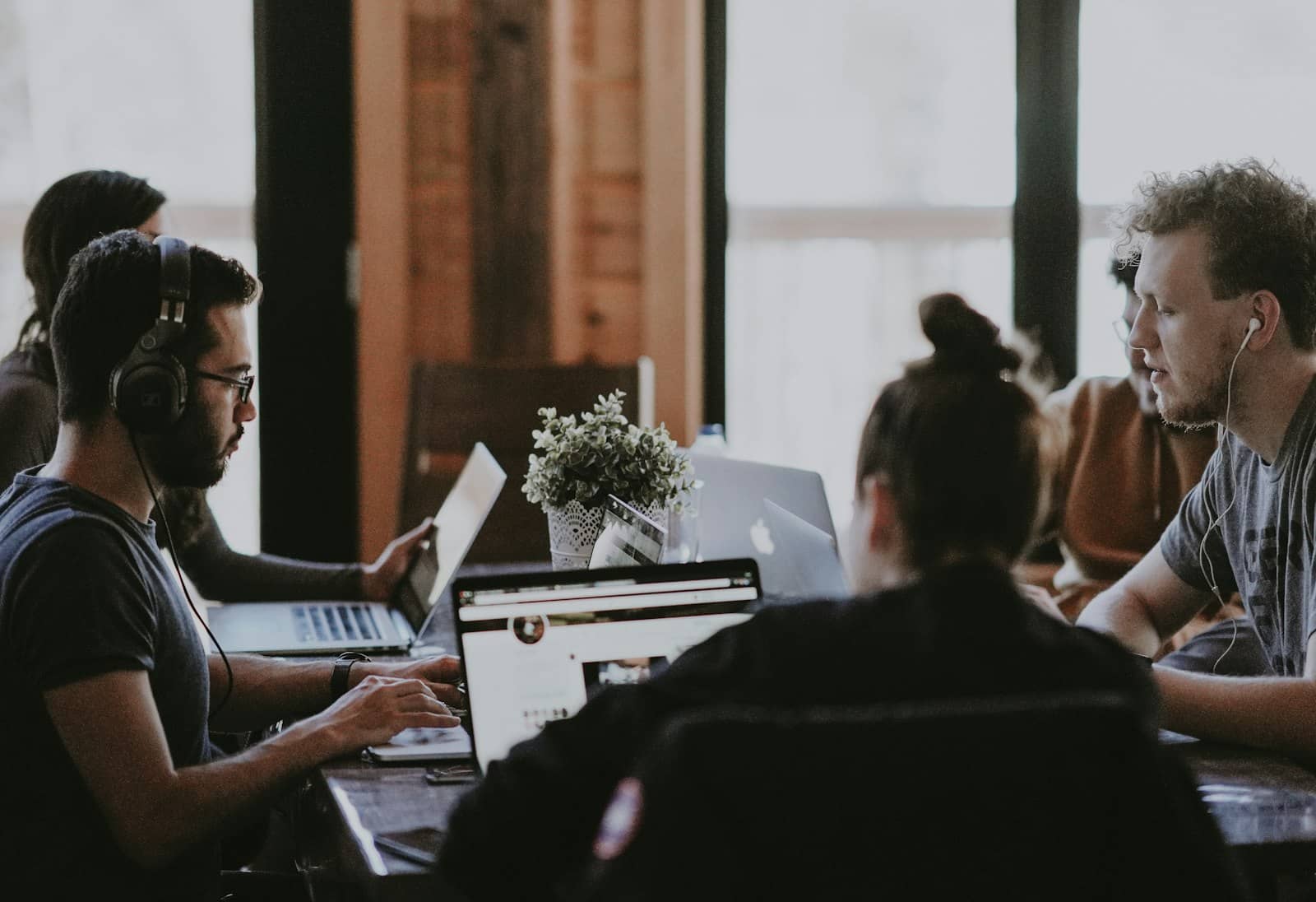 A small team reviewing work together at a desk
