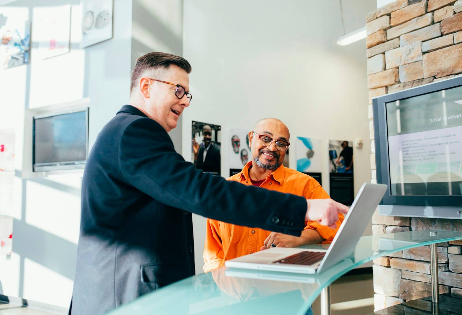 A team collaborating around shared customer records on screen